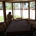 Jessica is staining the window sills that has been left dull when rain goes thru the window.